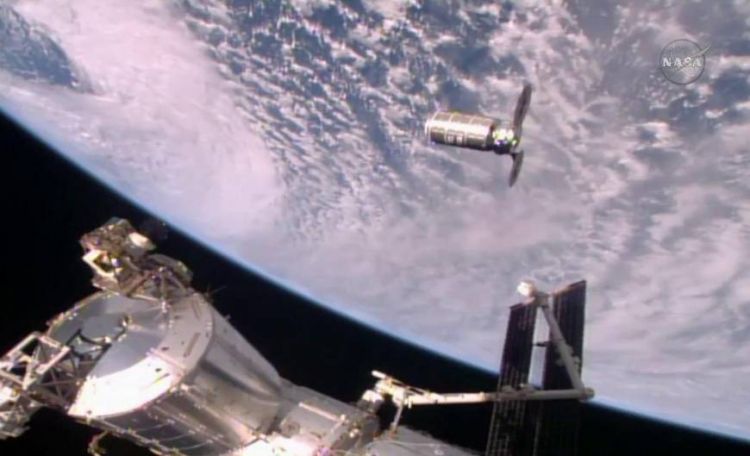 Japanese astronaut uses robotic arm to capture cargo ship upon its arrival at the International Space Station.
