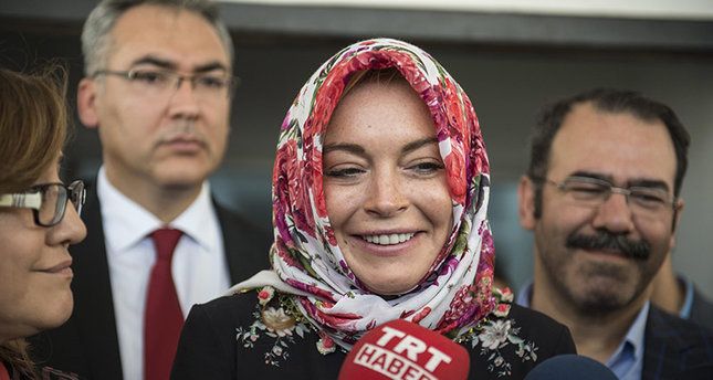 Lindsay Lohan says she was stopped for wearing a headscarf in London’s Heathrow airport