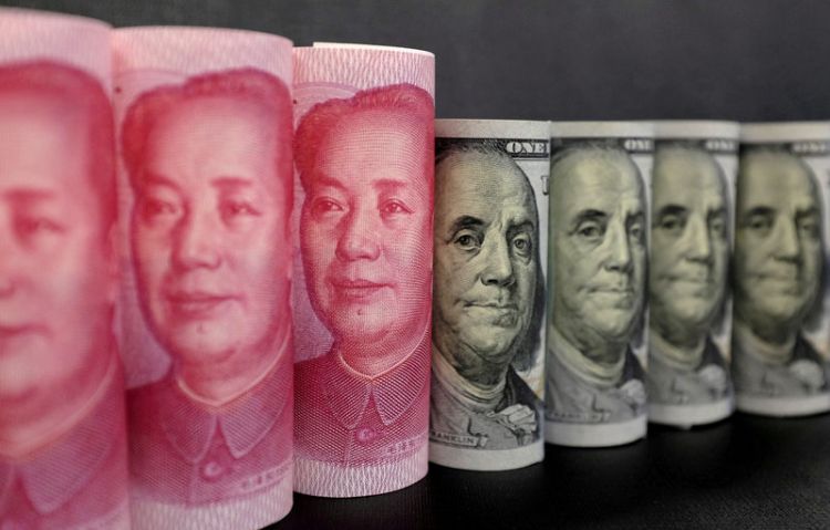 Dollar up in Asia as China loosens policy, yuan slips
