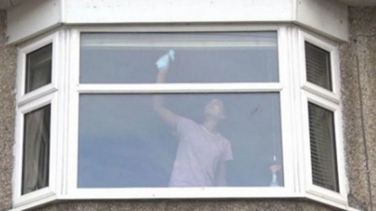 Photo of a woman cleaning windows is shared by UK police