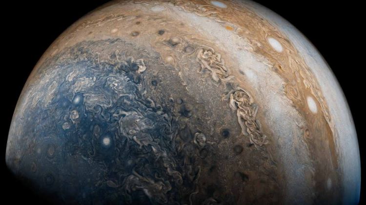 NASA probe beams back image of Jupiter’s swirling clouds