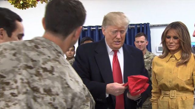 Troops bringing Trump hats to sign may violate military rule