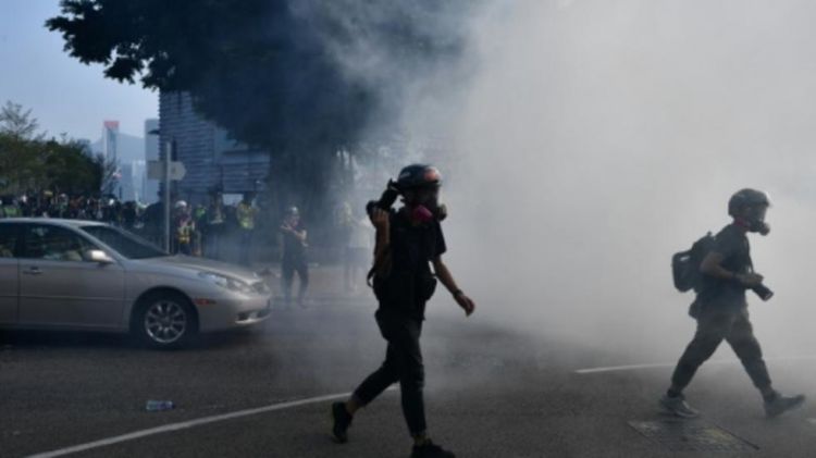 Hong Kong police fire tear gas at protesters on harbour front