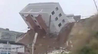 Entire building tumbles onto road in Mexico