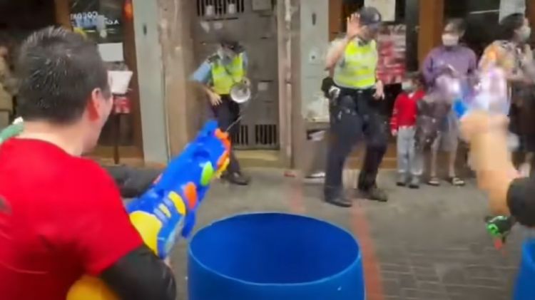 Hong Kong arrests two for shooting water guns at police